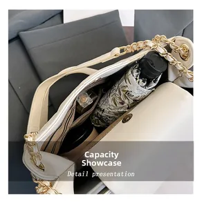 Interior view of large capacity cream tote bag with gold chain strap and daily items