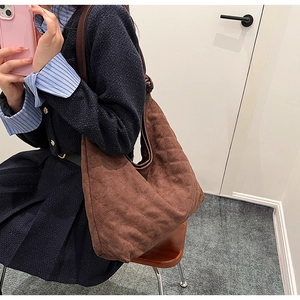 Brown quilted crossbody bag with large capacity shown on a model for daily commuting