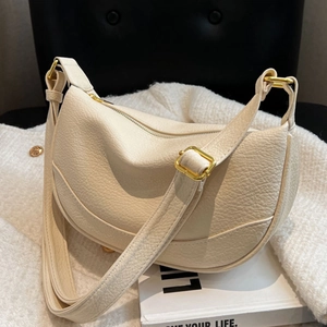 Minimalist creamy white leather half-moon shoulder bag with adjustable strap and gold hardware
