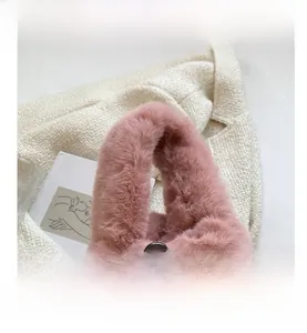 Detailed close-up of fluffy pink faux fur handbag with soft plush top handle design