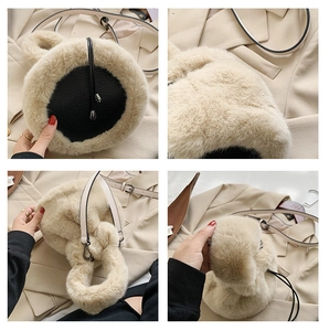 Detail view of plush beige faux fur bucket bag with black leather base and drawstring closure