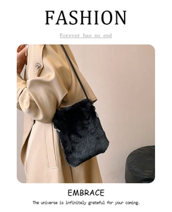 Detail of a chic black faux fur crossbody bag with a slim strap for autumn and winter