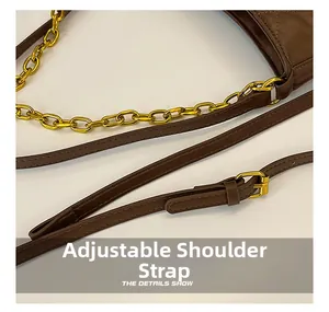 Detail of brown litchi pattern leather bag with adjustable strap and gold chain link