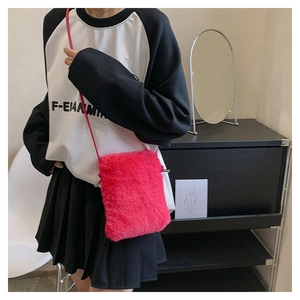 Detail of hot pink faux fur crossbody bag with soft texture and matching slim strap
