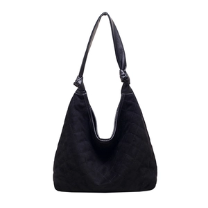 Large black quilted hobo shoulder bag in faux suede with knotted strap and minimalist design