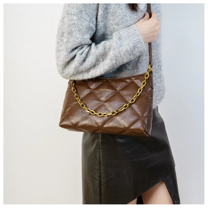 Detail of brown quilted shoulder bag with gold chain strap and Just & Fashion logo