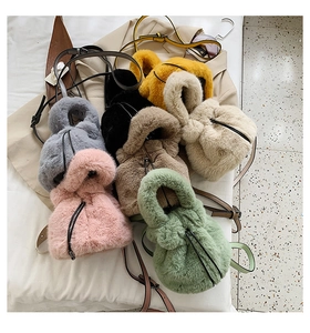 Detailed display of colorful faux fur bucket bags with drawstring closure and leather straps