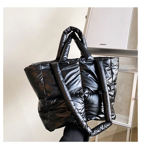 Detail of black down-quilted tote bag featuring glossy waterproof fabric and spacious interior