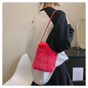Detail of soft faux fur texture on a vibrant hot pink crossbody bag for women