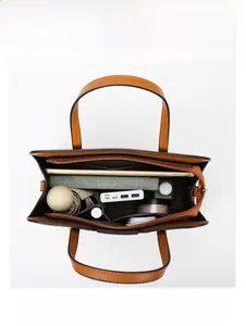 Top view of large capacity brown leather tote bag showing spacious interior with daily items