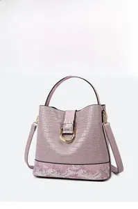 Detail of lavender croc-effect handbag with snake print trim and golden metal clasp