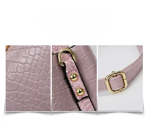 Detail of pink croc-embossed leather texture and premium gold-tone metal hardware accents