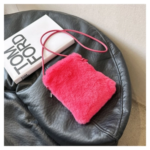 Macro view of the rose red plush crossbody bag with fluffy texture and metal zipper detail