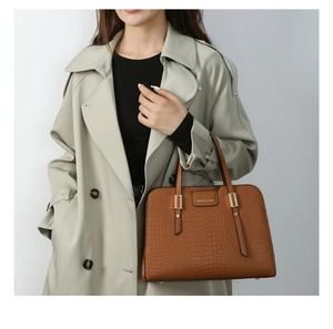 Detailed view of brown handbag with crocodile skin texture and Fashion & Bags logo