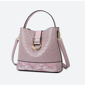 Detail of pink faux leather bucket bag with crocodile texture and snake skin patterns