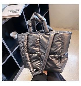 Metallic grey quilted tote bag with padded texture and dual straps for daily commute