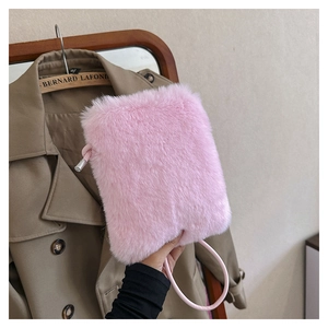 Close-up of pink faux fur crossbody bag detail with soft plush texture and shoulder strap