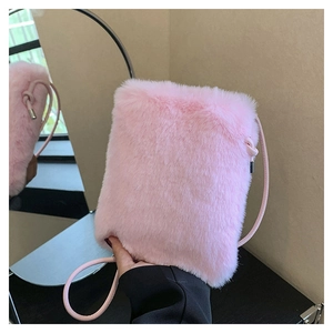 Close-up of pink plush crossbody phone bag showing soft faux fur texture and slim strap