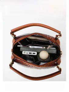 Interior view showing the large capacity and organized compartments of the brown tote bag