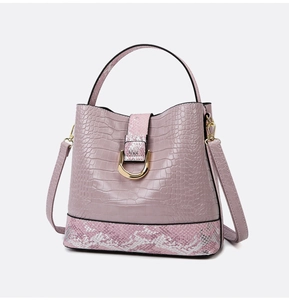 Detail of lavender crocodile embossed tote with snake pattern trim and gold metal hardware