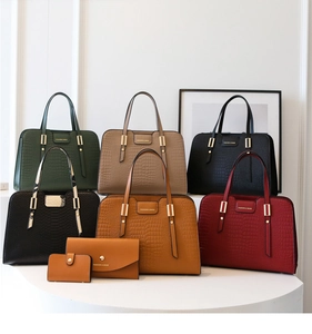 Detail of embossed crocodile pattern on luxury handbags set with gold metal accents