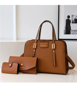 Detailed set of three brown faux leather handbags with embossed crocodile texture