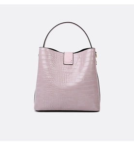 Detail view of the lavender crocodile pattern texture on a minimalist bucket handbag