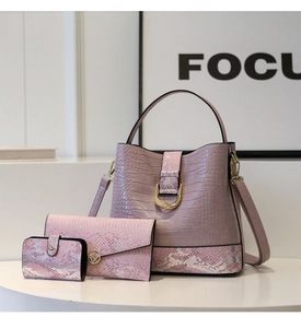 Detailed set of morandi pink bucket bag with crocodile embossed texture and gold hardware