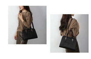 Detail showing high-quality black crocodile pattern embossed tote bag with gold metal buckles
