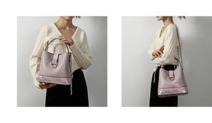Detail of purple crocodile texture bucket bag with snake skin trim and golden buckle