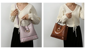 Detail of crocodile embossed bucket bag with metallic D-ring and dual-tone texture