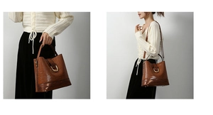 Detail of brown crocodile pattern bucket bag with gold hardware and adjustable strap