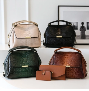 Detailed set of crocodile embossed handbags in multiple colors with gold metal accents