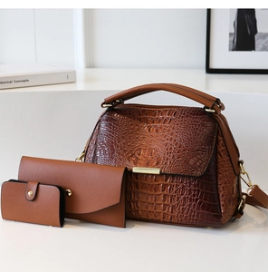 Detail of 3-piece brown crocodile pattern handbag set with wallet and card holder