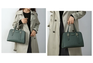 Detailed close-up of dark green crocodile embossed leather tote bag with gold logo