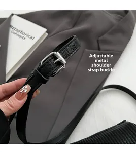 Detailed view of adjustable black lychee leather strap with silver square pin buckle