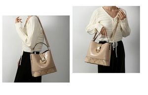 Detail of beige crocodile embossed bucket bag with snakeskin trim and golden horseshoe clasp