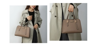 Detail of brown crocodile embossed tote bag with gold logo plaque and leather handles