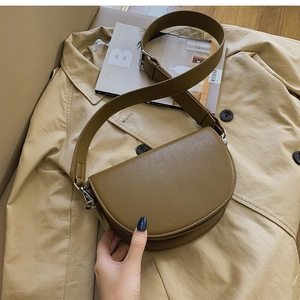 Détail du sac besace olive avec texture en cuir fin et large bandoulière réglable