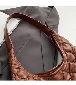 Close-up of caramel brown quilted PU leather tote featuring wide comfortable shoulder strap