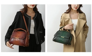 Detail of dark brown and green crocodile texture handbags with metal buckles and straps