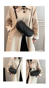 Detail of black pleated leather half-moon crossbody bag with silver hardware and zipper