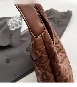 Macro shot of caramel quilted tote bag featuring detailed stitching and premium soft texture
