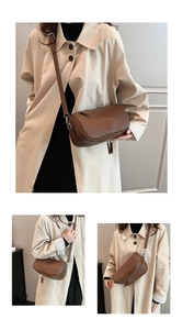 Detail view of brown pleated crossbody bag with dual zipper and adjustable shoulder strap