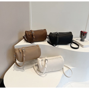 Detailed close-up of cylinder bags with pleated texture and adjustable straps