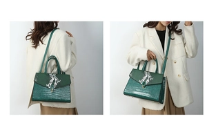 Detail of dark green embossed leather handbag featuring crocodile and snake textures
