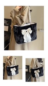 Close-up of the plush black tote bag featuring a large white bow and woven rope handles