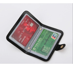 Detail view of the black crocodile pattern card holder with transparent PVC slots