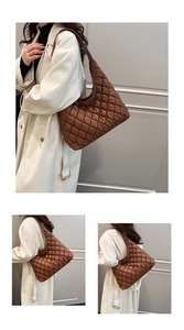 Detail of brown quilted diamond pattern on a large puffy nylon hobo shoulder bag
