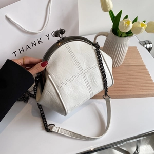 Minimalist white shell-shaped crossbody bag with vintage clasp and cross stitching